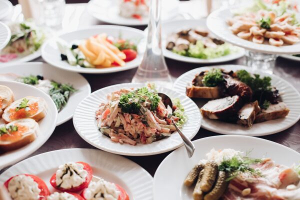 Banquet table served with various cold snacks and salads